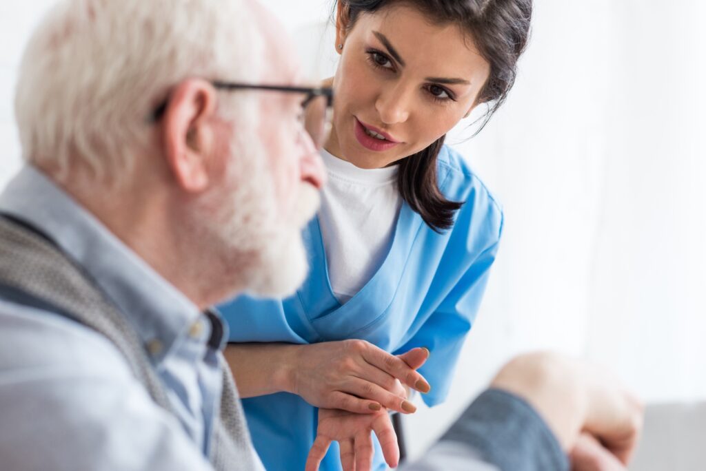 CNA talking to elderly man at home